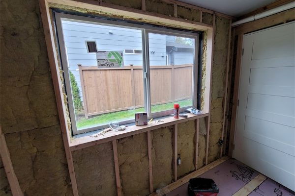 replace large window with vinyl patio door-before exterior view